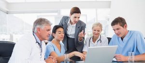 health professionals grouped together at a computer