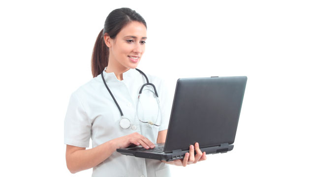 medical professional looking at laptop