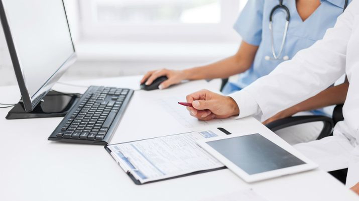 two people in healthcare setting working in clinical informatics