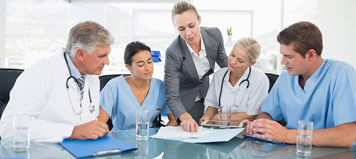 Team of doctors and health it pro having a meeting in medical office