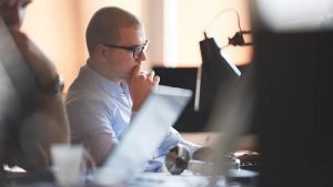 healthcare cyber security professional working on computer at modern office