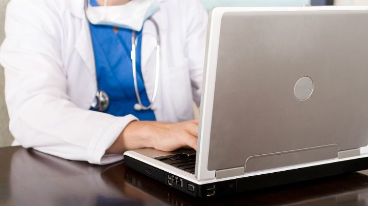 a clinician at a computer working in ehealth
