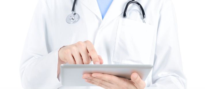 a doctor on a tablet looking at electronic medical records