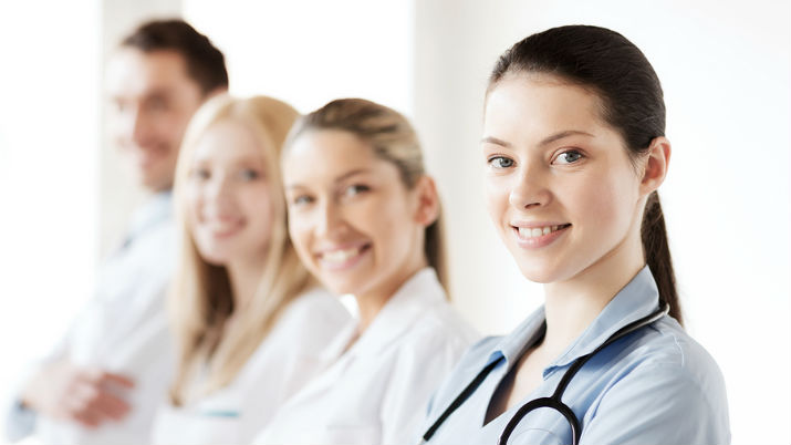 four healthcare professionals smiling