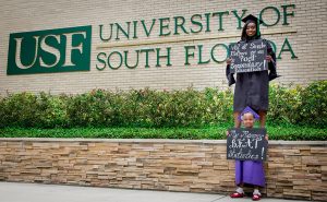 herlende saint phaird and daughter in cap and gown at USF