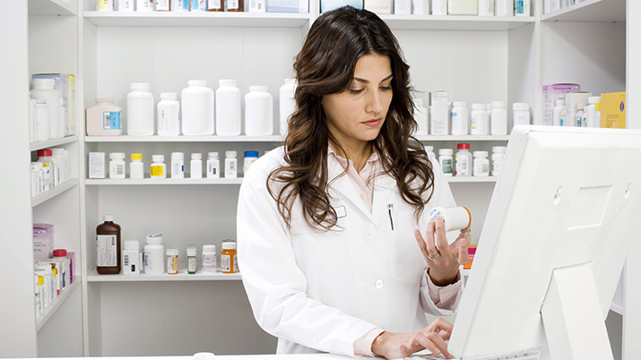 Pharmacist using computer