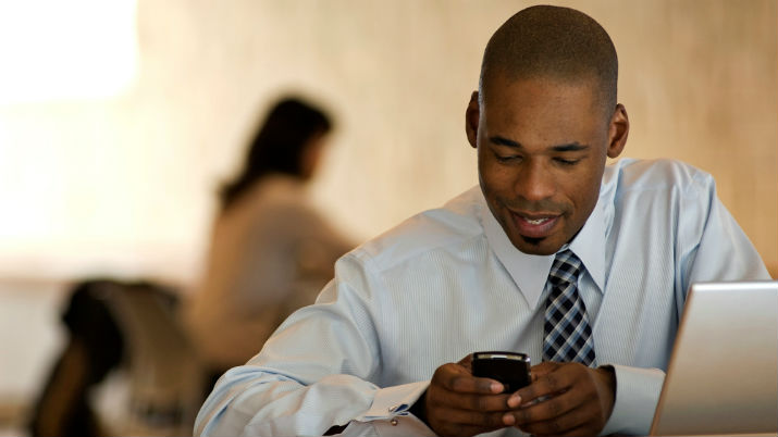 male professional looking at his blackberry