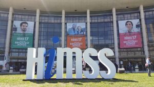 exterior of orlando convention center with himss logo in the foreground