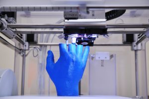 3D Printer printing blue hand