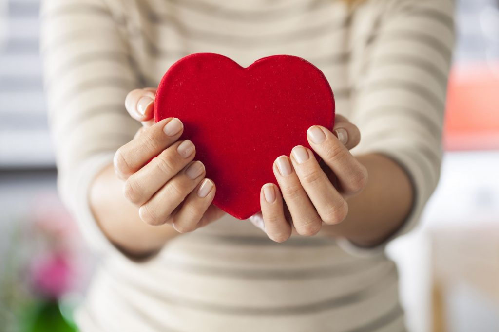 photo of someone holding a heart shaped item for heart month