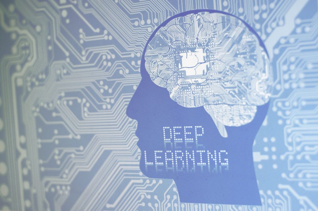 a graphic with the words digital learning on a motherboard with a man's silhouetted head and brain is visible