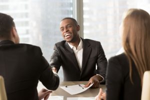 a man in a job interview smiling big