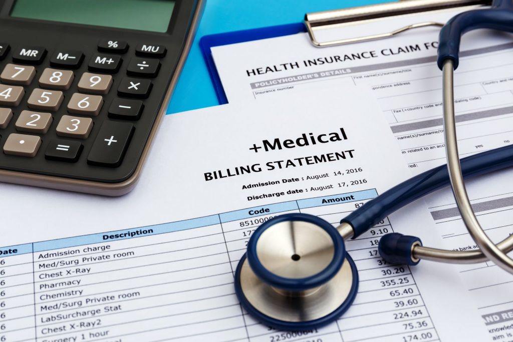 medical billing statements and calculator and stethoscope