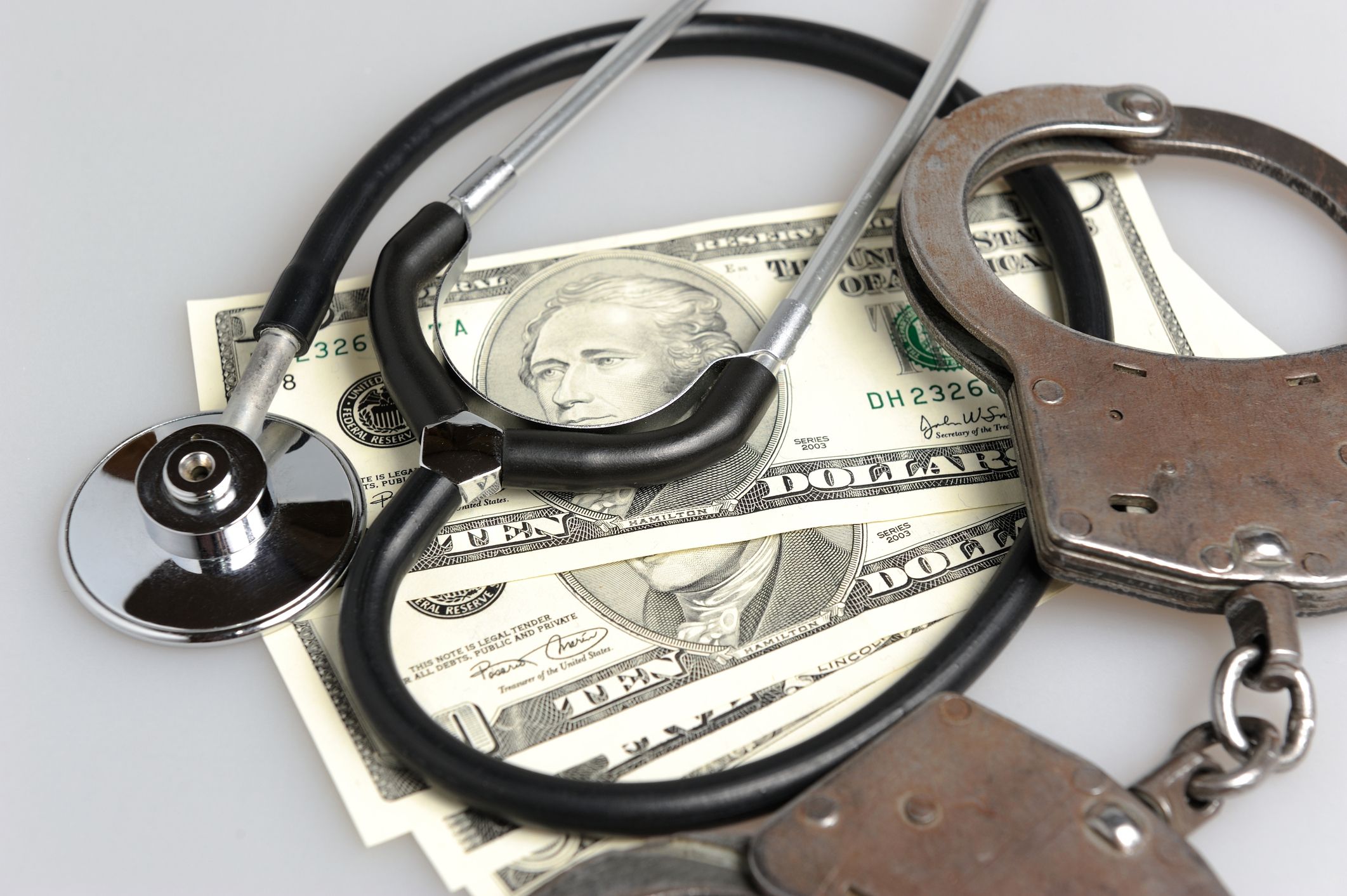 a stethoscope, handcuffs and four ten dollar bills