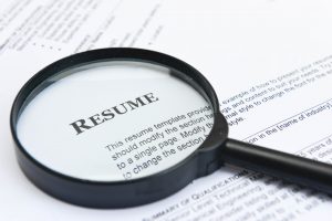 a resume with a magnifying glass over it
