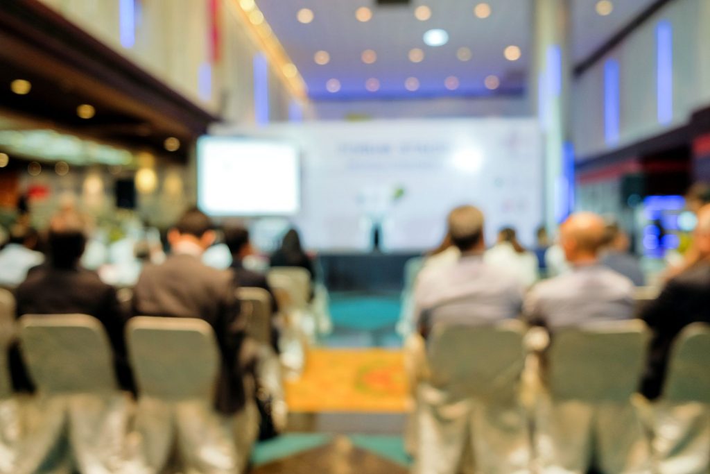 out of focus picture of a speaker session at a conference