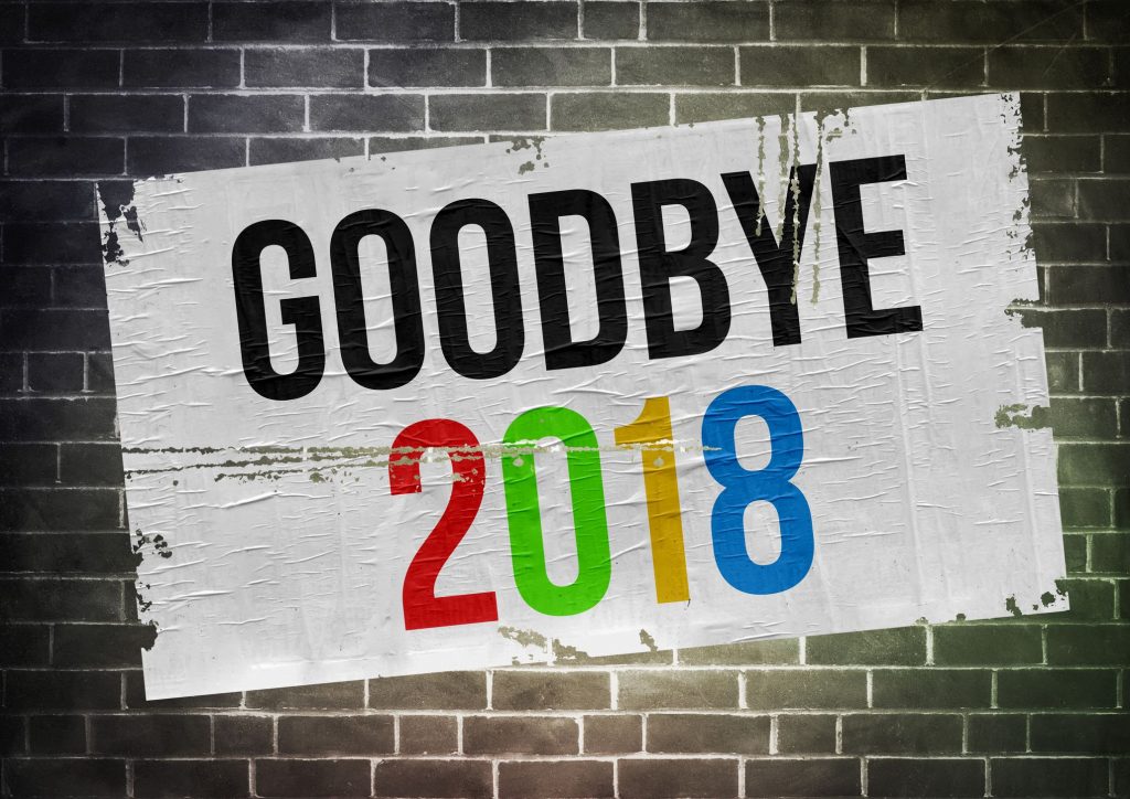 a plastered flyer on a brick wall that says goodbye 2018