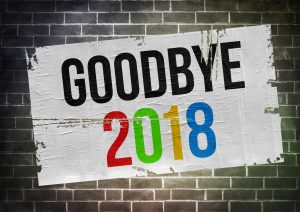 a plastered flyer on a brick wall that says goodbye 2018