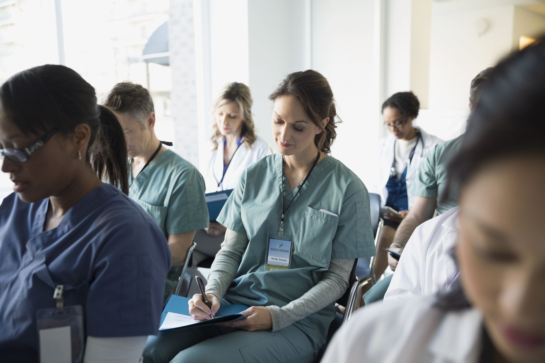 A diverse classroom of healthcare students takes notes at an educational institution.