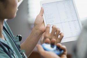 A nurse looks at an EMR on a tablet. Is this information useful to patients?